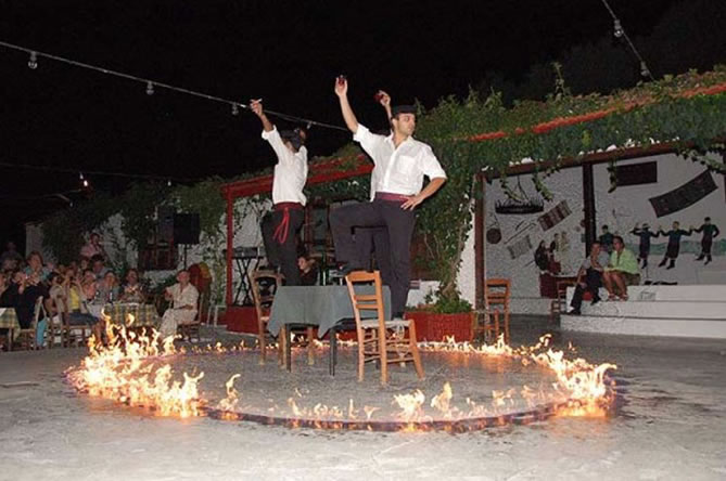 Local musicians and dancers performing at a Cretan night event